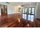 Bright living room features hardwood floors, french doors, arched doorways, and lots of light at 13809 18Th E Pl, Bradenton, FL 34212