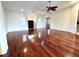Open living room with hardwood floors, natural light, ceiling fan, and front entry with double doors at 13809 18Th E Pl, Bradenton, FL 34212