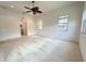Bright main bedroom with neutral carpet, ceiling fan, and natural light from two windows at 13809 18Th E Pl, Bradenton, FL 34212
