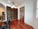 Comfortable office space features hardwood floors, built-in shelving, and a double door entrance at 13809 18Th E Pl, Bradenton, FL 34212