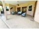 Covered patio with stucco walls, ample seating, and multiple doors and windows at 13809 18Th E Pl, Bradenton, FL 34212