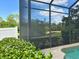 Screened-in pool area featuring lush landscaping and privacy, ideal for outdoor enjoyment at 13809 18Th E Pl, Bradenton, FL 34212