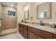 Modern bathroom with double vanity, stone countertops, walk-in shower and tile flooring at 1420 E Frierson Ave, Tampa, FL 33603