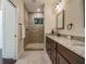 Modern bathroom featuring a tiled walk-in shower, granite countertop, and stylish vanity at 1420 E Frierson Ave, Tampa, FL 33603