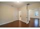Bedroom with hardwood floors and view into the ensuite bathroom and hallway at 1420 E Frierson Ave, Tampa, FL 33603