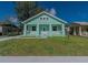 Charming bungalow with a covered front porch, updated siding, and a well-maintained lawn under a bright blue sky at 1420 E Frierson Ave, Tampa, FL 33603
