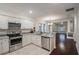 Bright eat-in kitchen with stainless steel appliances, stone countertops, and shaker cabinets at 1420 E Frierson Ave, Tampa, FL 33603