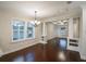 Spacious living room features dark hardwood floors, bright windows and decorative columns at 1420 E Frierson Ave, Tampa, FL 33603