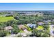 An aerial view showcasing a neighborhood and the surrounding landscape, including a body of water at 15208 21St E Ave, Bradenton, FL 34212