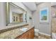 Bathroom featuring granite counters, a modern sink, and glass enclosed shower at 15208 21St E Ave, Bradenton, FL 34212