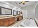 Stylish bathroom featuring a soaking tub, double vanities, and modern fixtures for ultimate relaxation at 15208 21St E Ave, Bradenton, FL 34212