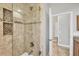 Bathroom featuring a tiled glass shower with recessed storage and bronze hardware at 15208 21St E Ave, Bradenton, FL 34212