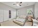 Bright bedroom with a modern bed, ceiling fan, closet, and unique hanging chair creating a cozy retreat at 15208 21St E Ave, Bradenton, FL 34212