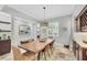 Formal dining room with a large wooden table, modern chandelier, and elegant décor, perfect for entertaining at 15208 21St E Ave, Bradenton, FL 34212