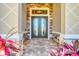 Elegant entryway features brick accents, lush landscaping, and double glass front doors at 15208 21St E Ave, Bradenton, FL 34212