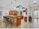 Bright kitchen with a stone breakfast bar, wooden cabinetry, and stainless steel appliances, offering ample counter space at 15208 21St E Ave, Bradenton, FL 34212