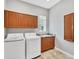 Laundry room equipped with granite counters, storage cabinets, and modern washer and dryer at 15208 21St E Ave, Bradenton, FL 34212