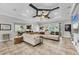 Spacious living room featuring tray ceilings and an oversized sectional sofa with access to an outdoor pool at 15208 21St E Ave, Bradenton, FL 34212
