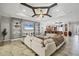 Stylish living room with built-in shelving, a large sectional sofa, and an open view into the gourmet kitchen at 15208 21St E Ave, Bradenton, FL 34212