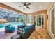 Screened in patio featuring outdoor seating, a built in fire pit, and views of the pool at 15208 21St E Ave, Bradenton, FL 34212