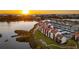 Waterfront living at sunset with community buildings and a tranquil waterfront at 1608 Stickney Point Rd # 304, Sarasota, FL 34231