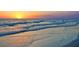 A wide shot shows beautiful Gulf waves as they roll on the white sugar sand of the beautiful beach at 1608 Stickney Point Rd # 304, Sarasota, FL 34231