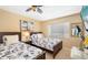 Bright bedroom with two beds, light tan walls, and nautical decor at 1608 Stickney Point Rd # 304, Sarasota, FL 34231