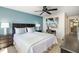 Bedroom with queen bed, lamps, and beach themed wall art at 1608 Stickney Point Rd # 304, Sarasota, FL 34231