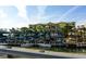 An exterior elevation of dry boat storage on a canal with waterfront condominiums in the background at 1608 Stickney Point Rd # 304, Sarasota, FL 34231