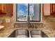 Close up of stainless sink with gooseneck faucet and granite countertop at 1608 Stickney Point Rd # 304, Sarasota, FL 34231