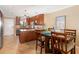 Kitchen and breakfast area with wood cabinetry, granite countertops, and stainless appliances at 1608 Stickney Point Rd # 304, Sarasota, FL 34231
