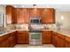 Kitchen with stainless oven, granite countertops, and wood cabinetry at 1608 Stickney Point Rd # 304, Sarasota, FL 34231