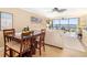 Open-concept living room and dining area with water views and modern decor at 1608 Stickney Point Rd # 304, Sarasota, FL 34231