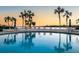 Resort-style pool with seating area, palm trees, and waterfront view at 1608 Stickney Point Rd # 304, Sarasota, FL 34231