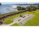 Scenic shuffleboard court by the waterfront with lush green surroundings at 1608 Stickney Point Rd # 304, Sarasota, FL 34231