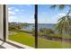 Water view from balcony of grassy area, shuffleboard, and waterfront at 1608 Stickney Point Rd # 304, Sarasota, FL 34231