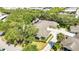 An aerial view shows this home's roof, solar panels, landscaping, and a long driveway at 1651 Red Oak Ln, Port Charlotte, FL 33948