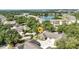 Scenic aerial view of a community with lush landscaping, a tranquil lake, and well-maintained residential buildings at 1651 Red Oak Ln, Port Charlotte, FL 33948