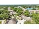 Scenic aerial view of a community with lush landscaping, a tranquil lake, and well-maintained residential buildings at 1651 Red Oak Ln, Port Charlotte, FL 33948