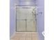 A tiled shower with glass door features a handheld shower head and a chrome towel bar at 1651 Red Oak Ln, Port Charlotte, FL 33948