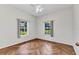 A bright bedroom with parquet flooring and large windows offers a cheerful and inviting space at 1651 Red Oak Ln, Port Charlotte, FL 33948