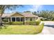 Well-maintained home with a screened-in porch and lush landscaping showcasing curb appeal at 1651 Red Oak Ln, Port Charlotte, FL 33948