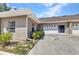 Home exterior with a two-car garage and tidy landscaping at 1651 Red Oak Ln, Port Charlotte, FL 33948