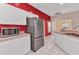 Kitchen area features stainless steel refrigerator, white cabinets, and tile flooring at 1651 Red Oak Ln, Port Charlotte, FL 33948