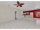 Open-concept living space with tile flooring, ceiling fan, and bright natural light at 1651 Red Oak Ln, Port Charlotte, FL 33948