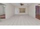 Spacious living room with tile flooring and natural light from a large window at 1651 Red Oak Ln, Port Charlotte, FL 33948