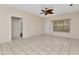 Spacious living room features tile floors, a ceiling fan, and natural light at 1651 Red Oak Ln, Port Charlotte, FL 33948