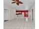 Spacious living area with tile flooring, ceiling fan, and open concept to the kitchen at 1651 Red Oak Ln, Port Charlotte, FL 33948