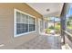 Enclosed screened porch with tiled flooring, providing an enjoyable outdoor living area at 1651 Red Oak Ln, Port Charlotte, FL 33948