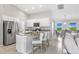 Open kitchen features a breakfast bar, stainless steel appliances and plenty of natural light at 17065 Kellog Ave, Port Charlotte, FL 33954